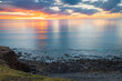 Dramatic sunset with fishing boat viewed from Hallett Cove Beach, South Australia