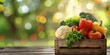 Colorful fresh vegetables in a rustic wooden crate on a blurred green background, symbolizing healthy eating.