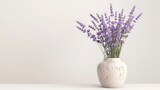 Fototapeta Lawenda - a white vase with lilas are sitting on top of a dresser table, lavender in glass vase on wooden background, romantic background. Fresh natural lavender against a white wall background