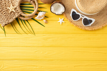 Wall Mural - Beach vibes captured: top view of straw hat, sunglasses, coconuts, woven bag, palm leaf, shells, and starfish arranged on a yellow wooden desk, perfect for summer promotions