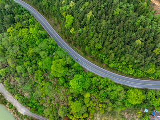 Wall Mural - Aerial photography of the winding mountain road by the river