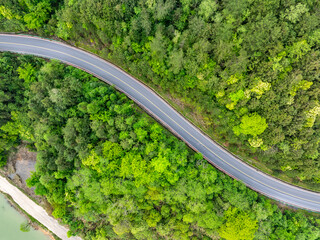 Wall Mural - Aerial photography of the winding mountain road by the river