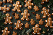 © lashkhidzetim - A group of gingerbread men are sitting on a table with cinnamon and other spices. Scene is festive and warm, as it is a representation of the holiday season