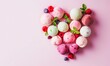 Assorted  various colorful fruits ice laid out in the shape of a heart on light pink background.  Fruits ice cream balls and berries, Summer cool desserts concept. World ice cream day, Place for text