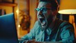 Angry man reacting to computer screen - Heated moment of a man with glasses yelling at his computer during night time work