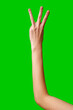 Human Hand Displaying the Number Three Against a Solid Green Background