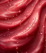 Background of red lip gloss, waves with water drops. Smudged makeup product sample. 