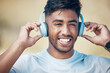 © peopleimages.com - Face, fitness and music with runner Indian man outdoor for cardio training, health or wellness. Exercise, headphones and smile with confident athlete running in nature for physical improvement