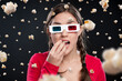 © peopleimages.com - Woman, 3d glasses and portrait with popcorn for snack, eating or watching movie in black studio background. Female person, food and futuristic with color lens eyewear in cinema for film or hologram