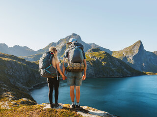 Wall Mural - couple backpackers hiking in mountains friends exploring norway together active healthy lifestyle ou