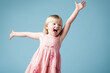 Studio, child or girl excited with dance for surprise, happy or isolated on blue background. Model, backdrop or kid for announcement with face reaction of wow, omg or shocked emoji with mind blown