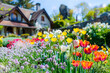 Assortment of colorful flowers in front of house