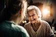 Happy Smiling Elderly Woman Talking To Her Middle-Aged Daughter Indoors