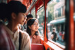 Asian tourists board double-decker bus in city