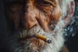 Old senior man smoking a cigarette close-up