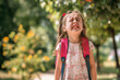 © Ирина Щукина - A little girl is crying while holding her backpack