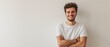 © artbot - Happy young man positive expression posing with crossed hands on white background with copy space