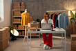 Fashion designer kneeling at workspace