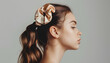 Woman with silk scrunchies on ponytail against grey background