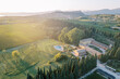 Villa Cordevigo among green trees and vineyards with mountains and lake Garda in the background. Italy. Drone