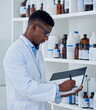 © peopleimages.com - Black man, scientist and folder for inventory in lab for medical stock, update and products checklist. Doctor writing, pharmacist or bottles with chemical supply for research on paper or report