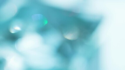 Wall Mural - Iridescent Blue Crystalline Luster. Loop. The light passes through the facets of a slowly rotating diamond and creates repetitive sparkling highlights and rainbow colors