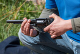 Fototapeta Do pokoju - Six-shot revolver in the hand of a shooter