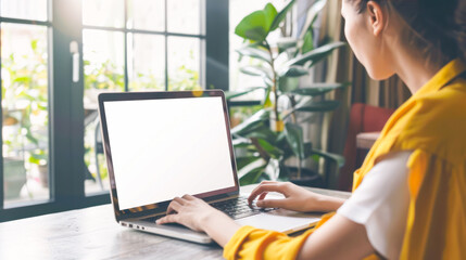 Laptop with blank white screen being used by woman. Female student e-learning distance training course study, work at home office. Young woman watching online education webinar using laptop mock up