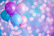Set of colorful helium balloons floating on colorful bokeh background.