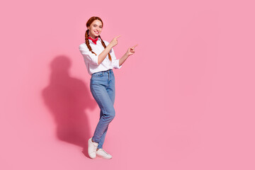 Full length photo of adorable cute lady dressed cowboy outfit pointing two fingers looking emtpy space isolated pink color background