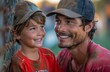 © DKPhoto - Smiling father and young son in baseball caps share a happy moment during a sports game
