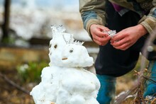 The Snowman Is Not Just Built By Children; Adults Too Find Joy And Relaxation In Contributing To His Creation.

