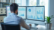 © Ali - sales manager looking at the sales data statistics of business on computer screens in modern office, growth analysis, businessperson or data analyst working with sales data