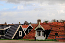 The Roofs Of Houses In The Dutch Village Of Dalmeer Tower Over The Dam On The North Holland Canal