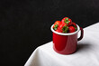 Fresh strawberries in enamel mug