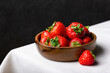 Fresh strawberries in wooden bowl