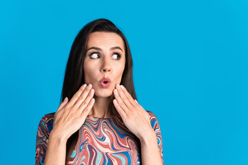 Poster - Photo portrait of pretty young girl shocked reaction look empty space wear trendy colorful clothes isolated on blue color background