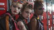 Youthful rebellion captured among school lockers, rockers with bold makeup and flashy accessories standing out