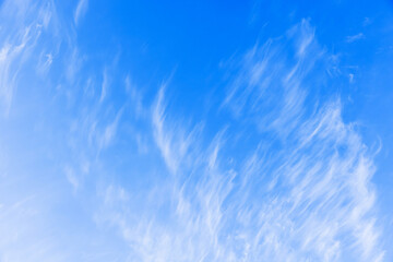 Wall Mural - white clouds in blue sky on a windy day, natural background texture