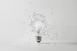 Photorealistic transparent light bulb standing vertically on a table and shattering into shards in various directions. Brainstorming concept. White background.