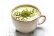 A white cup with green powder on top. The powder is likely matcha, a type of green tea