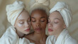 Three women dressed in bathrobes after beauty treatments, close-up portrait