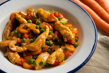 Wall Mural - Chicken strips sautéed with peppers, peas, onion and carrot.