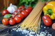 A vibrant display of fresh ingredients including tomatoes, garlic, and uncooked spaghetti, ready for an Italian culinary creation