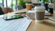 Close-up of a coffee cup next to a smartphone and paperwork, illustrating a dynamic and efficient workspace environment.