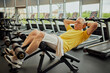 Focused on training senor man in vibrant sports gear doing abdominal exercises at modern fitness center for retirements. Concept of sport, active seniors in modern life, healthy lifestyle. Ad