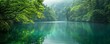 A peaceful scene featuring a calm lake embraced by vibrant green foliage, inspiring tranquility and serenity.