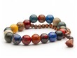 A bracelet made of colorful round gemstone beads with a tassel.