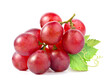 Red grape cluster with leaves isolated on white background.
