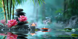 The spa background features bamboo, pink lotus flowers and black stones stacked on water background, zen, peaceful